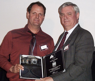 Bryan (left) receiving "Award of Excellence"